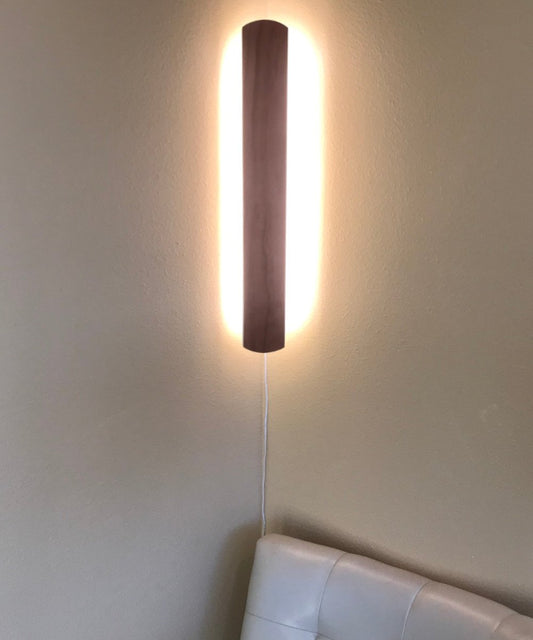 Solid wood wall accent light with hover plank design illuminated